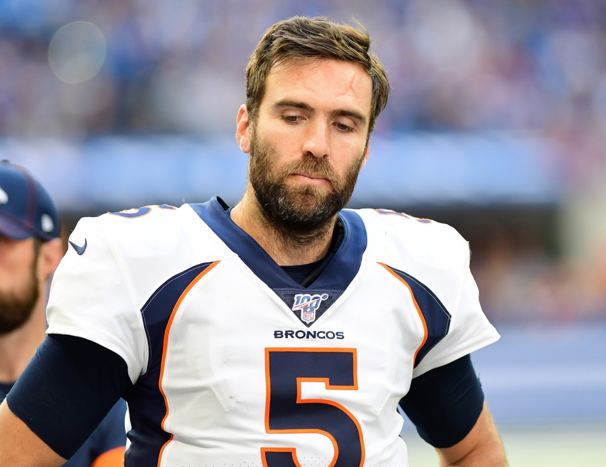 Denver Broncos quarterback Joe Flacco (5) walks to the huddle during the fourth quarter against the Indianapolis Colts at Lucas Oil Stadium.